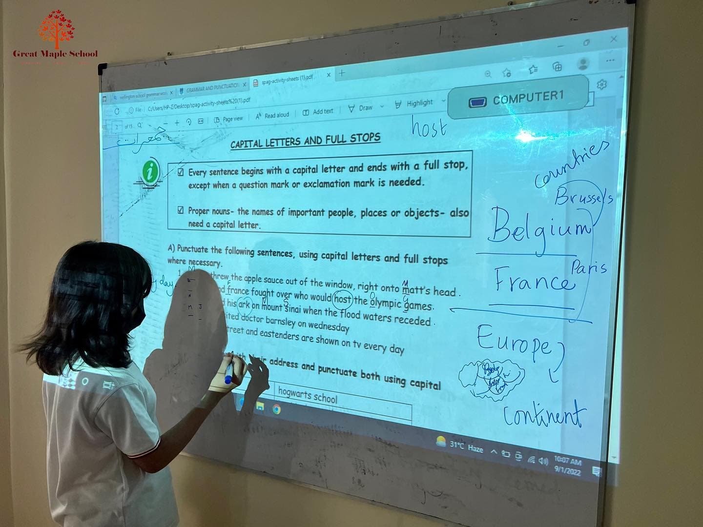 Teacher using a projector in class
